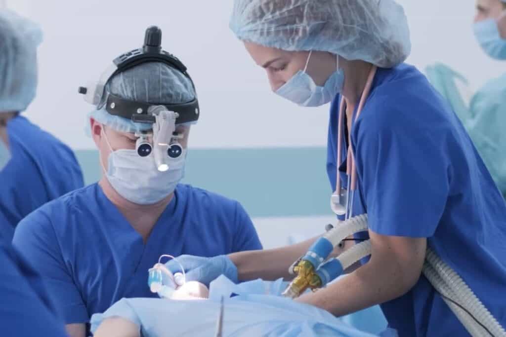 doctors operating on patient with a breathing tube